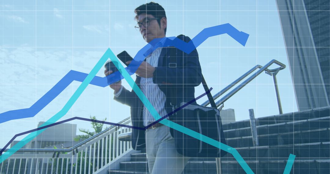 Asian Businessman on Phone with Overlaid Graphs Concept