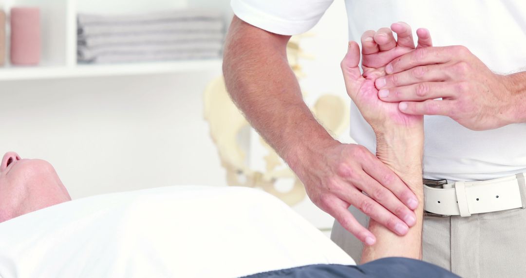 Physical Therapist Assisting Patient with Wrist Exercise - Free Images, Stock Photos and Pictures on Pikwizard.com