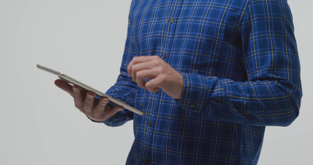 Person Using Tablet in Casual Blue Plaid Shirt - Free Images, Stock Photos and Pictures on Pikwizard.com