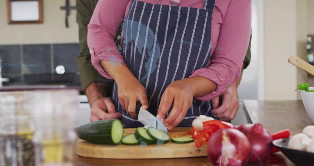 Couple Cooking Together Slicing Cucumber While Partner Guiding Hands for Safe Knife Skills