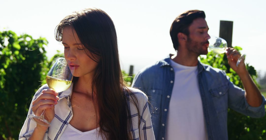 Couple Enjoying Wine Tasting in Sunny Vineyard
