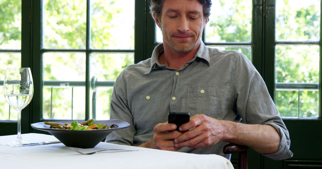  Handsome man texting in a restaurant - Free Images, Stock Photos and Pictures on Pikwizard.com