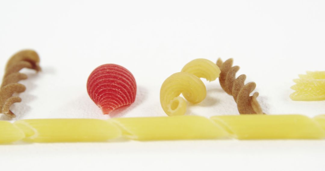 Assorted Colorful Pasta Shapes on White Background - Free Images, Stock Photos and Pictures on Pikwizard.com