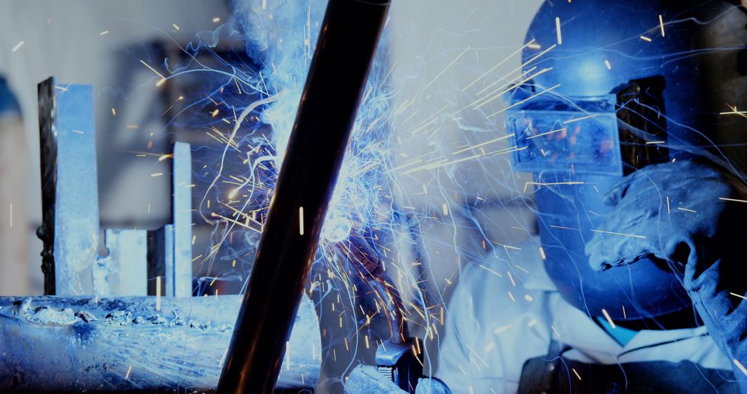 Welder Working with Sparks Flying in Industrial Setting - Free Images, Stock Photos and Pictures on Pikwizard.com