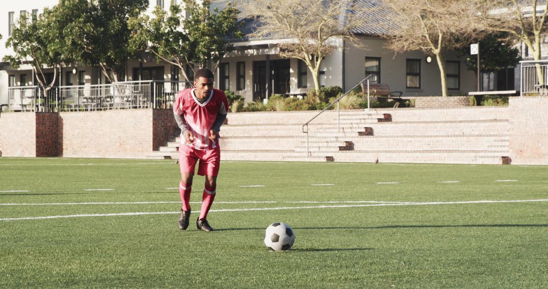 Youth Soccer Player Practicing Ball Control on Sunny Field
