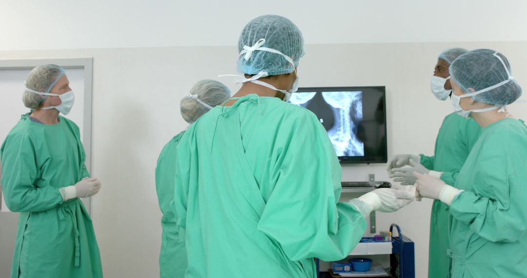 Medical Team Discussing Surgery Plan in Operating Room - Free Images, Stock Photos and Pictures on Pikwizard.com