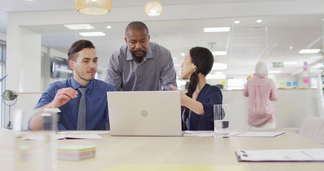 Diverse Team Collaborating in Modern Office on Laptop Project
