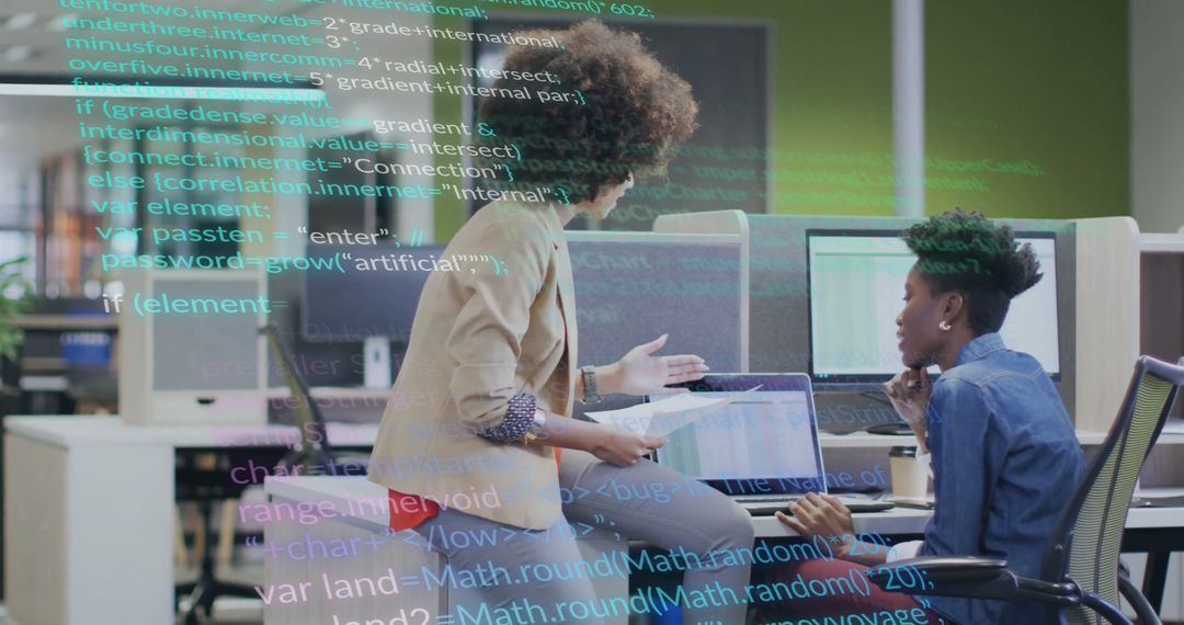 Female Colleagues Collaborating on Data Processing Project in Modern Office