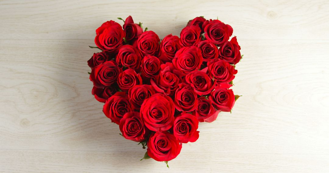 Heart Shaped Arrangement of Red Roses on Wooden Background - Free Images, Stock Photos and Pictures on Pikwizard.com
