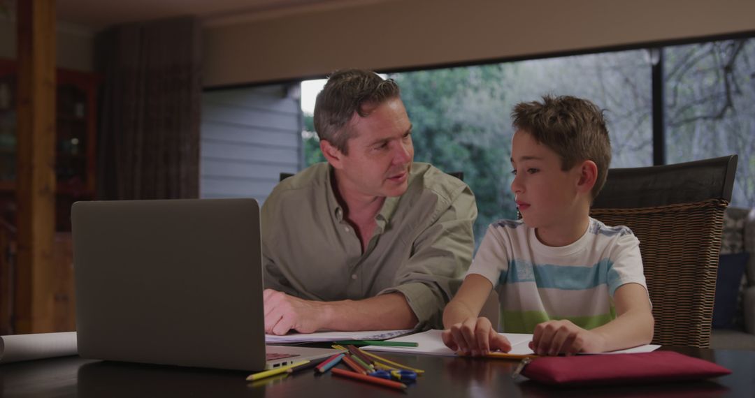 Father Helping Son with Online Homework at Home - Free Images, Stock Photos and Pictures on Pikwizard.com