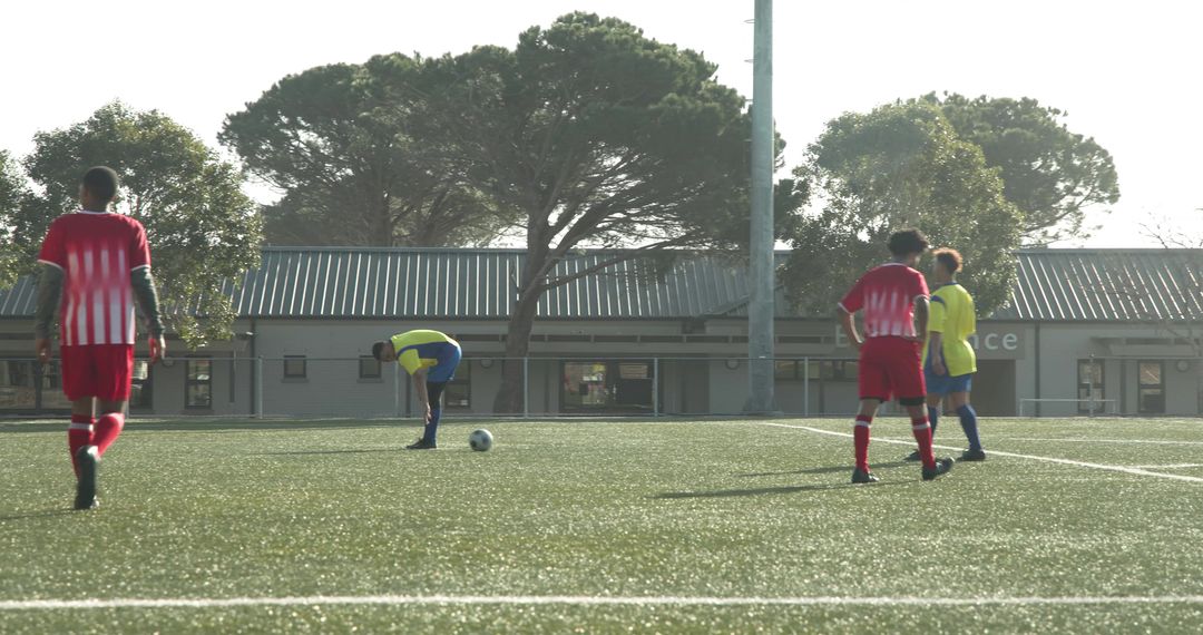 Youth Players Preparing for Soccer Match on Sunny Field
