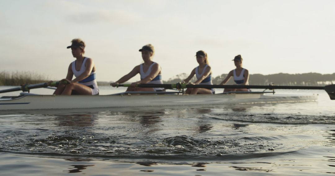 Women's Rowing Team Practicing on Calm Lake at Sunset - Free Images, Stock Photos and Pictures on Pikwizard.com