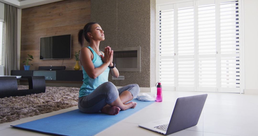 Woman Practicing Yoga Meditating at Home with Laptop - Free Images, Stock Photos and Pictures on Pikwizard.com