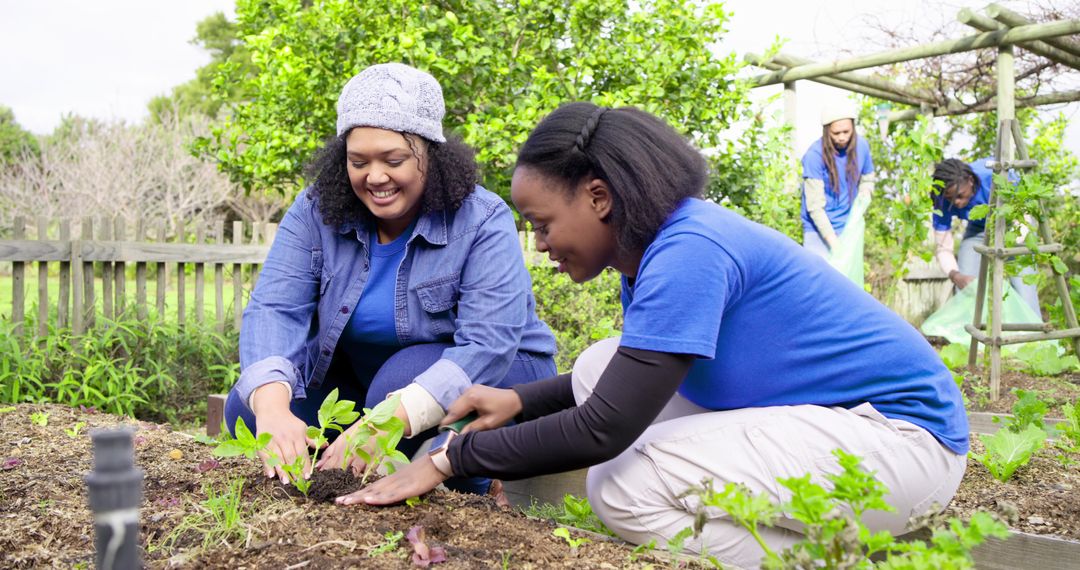 Diverse volunteers planting seedlings and tending raised beds in community garden