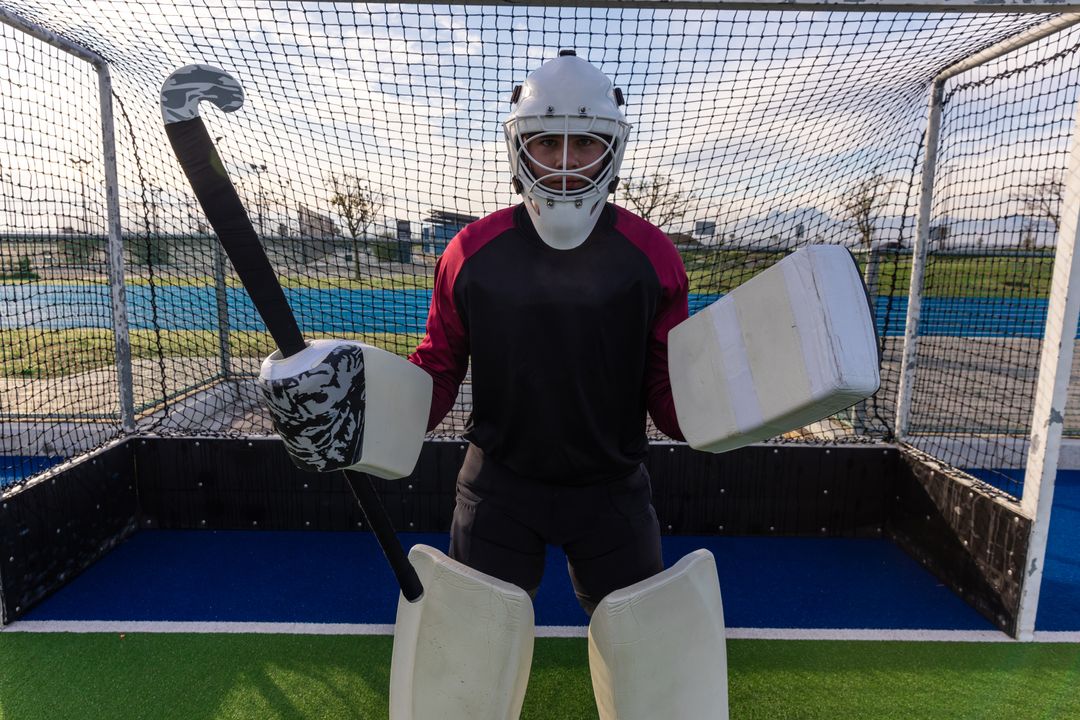 Field Hockey Goalkeeper Standing Ready with Stick and Protective Gear