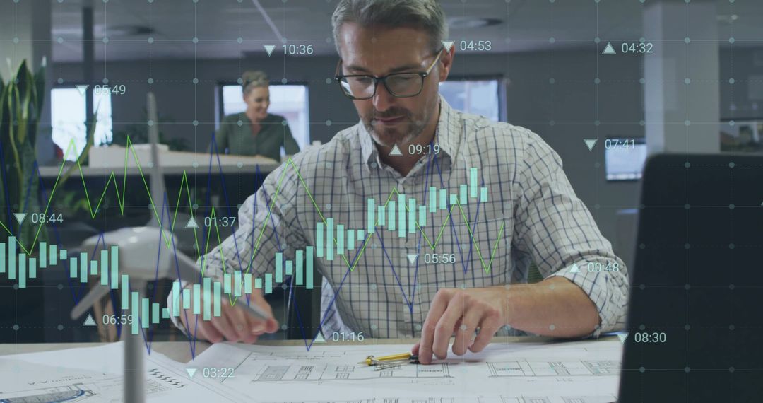 Businessman Analyzing Financial Data Charts in Modern Office
