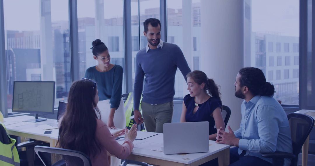 Multicultural Team Collaborating in Modern Office Space with Architecture Plans