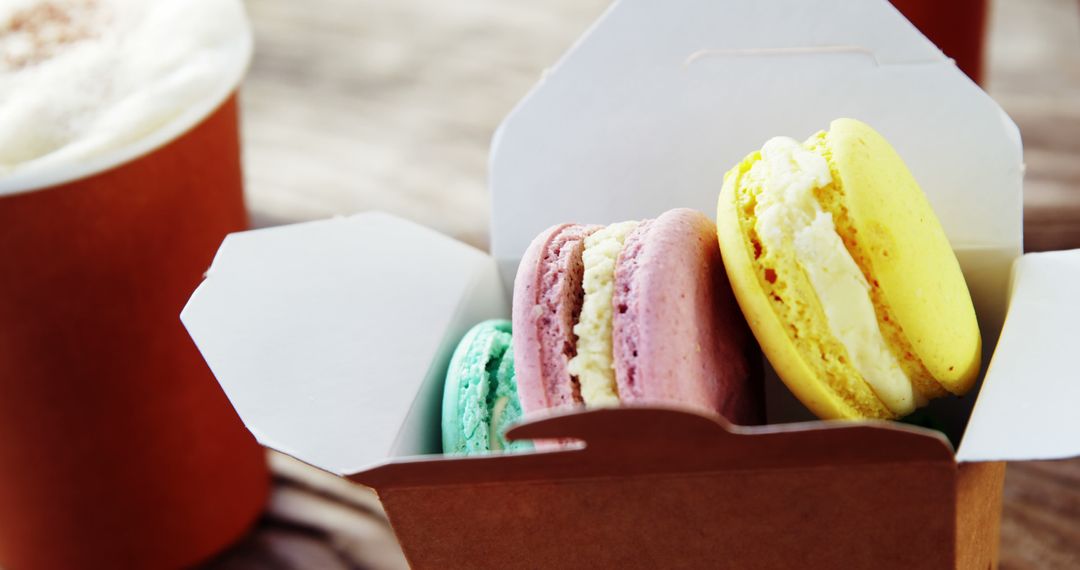 Colorful Macarons in Takeout Box with Coffee Cup - Free Images, Stock Photos and Pictures on Pikwizard.com