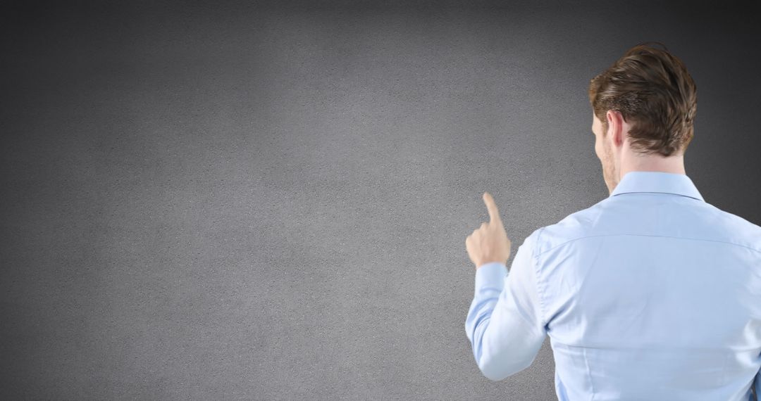 Businessman Touching Invisible Interface on Grey Background