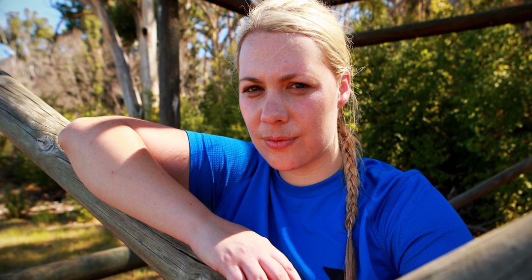 Confident Woman in Blue Shirt Taking a Break During Outdoor Workout - Free Images, Stock Photos and Pictures on Pikwizard.com