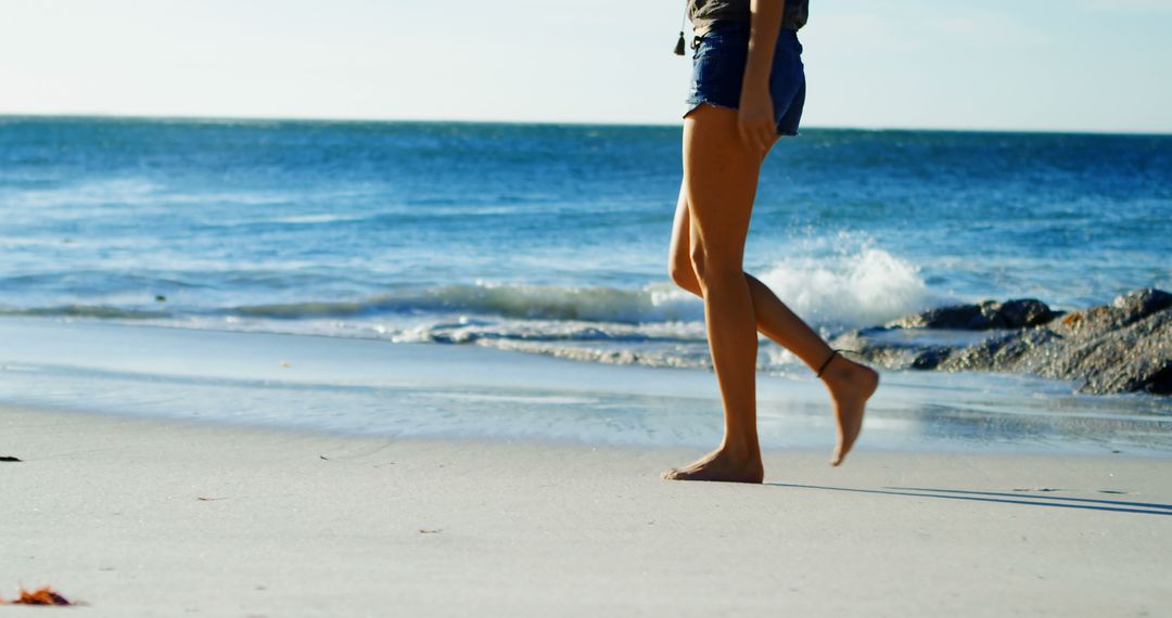 Woman Walking on Sandy Beach at Seaside - Free Images, Stock Photos and Pictures on Pikwizard.com