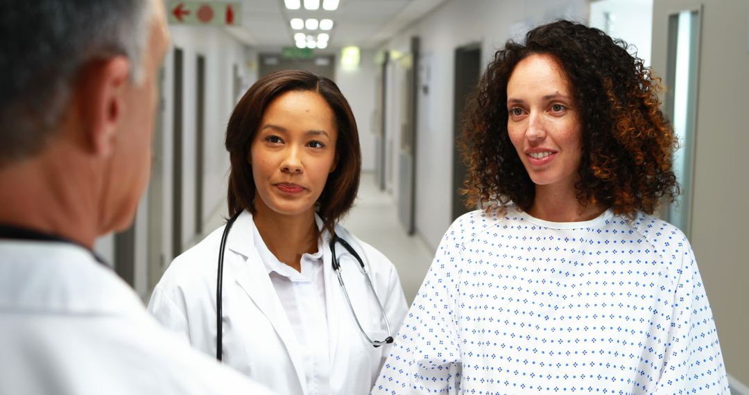 Female Doctor Reassuring Patient in Hospital Corridor - Free Images, Stock Photos and Pictures on Pikwizard.com