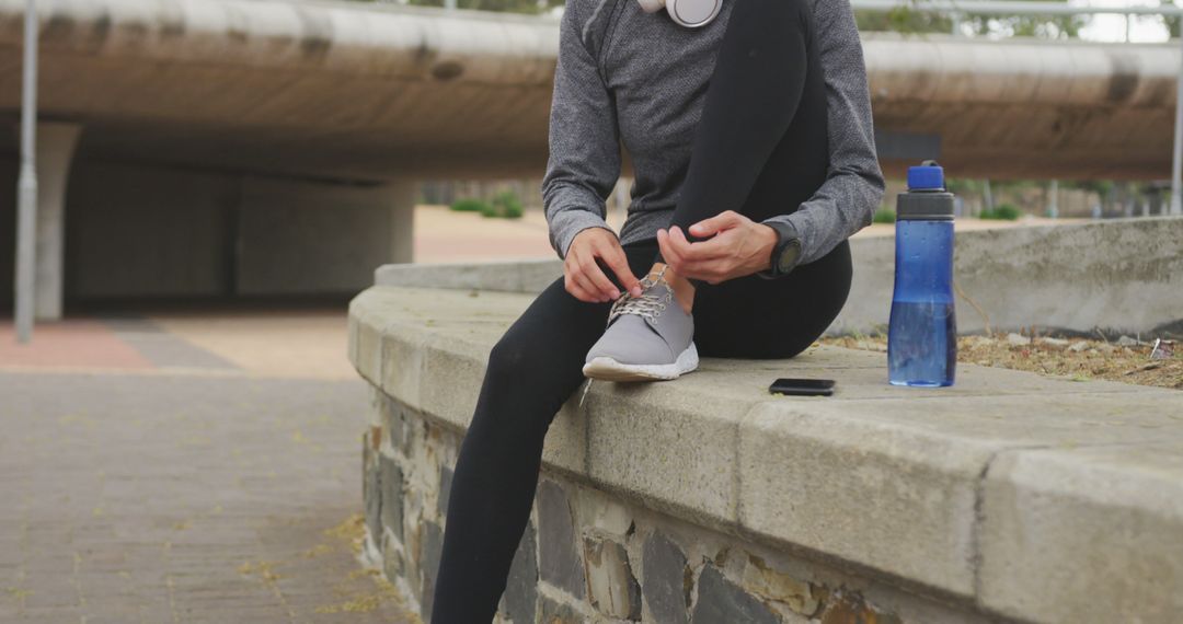 Jogger Sitting on Bench Tying Shoes Before Morning Run - Free Images, Stock Photos and Pictures on Pikwizard.com