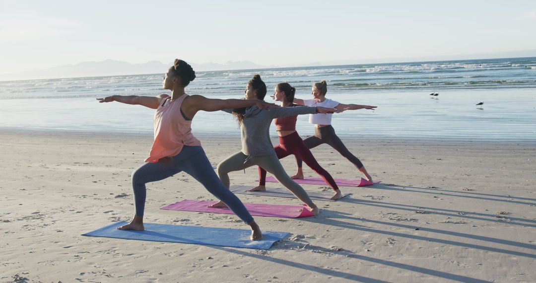 Diverse Group Practicing Yoga on Beach During Sunrise - Free Images, Stock Photos and Pictures on Pikwizard.com