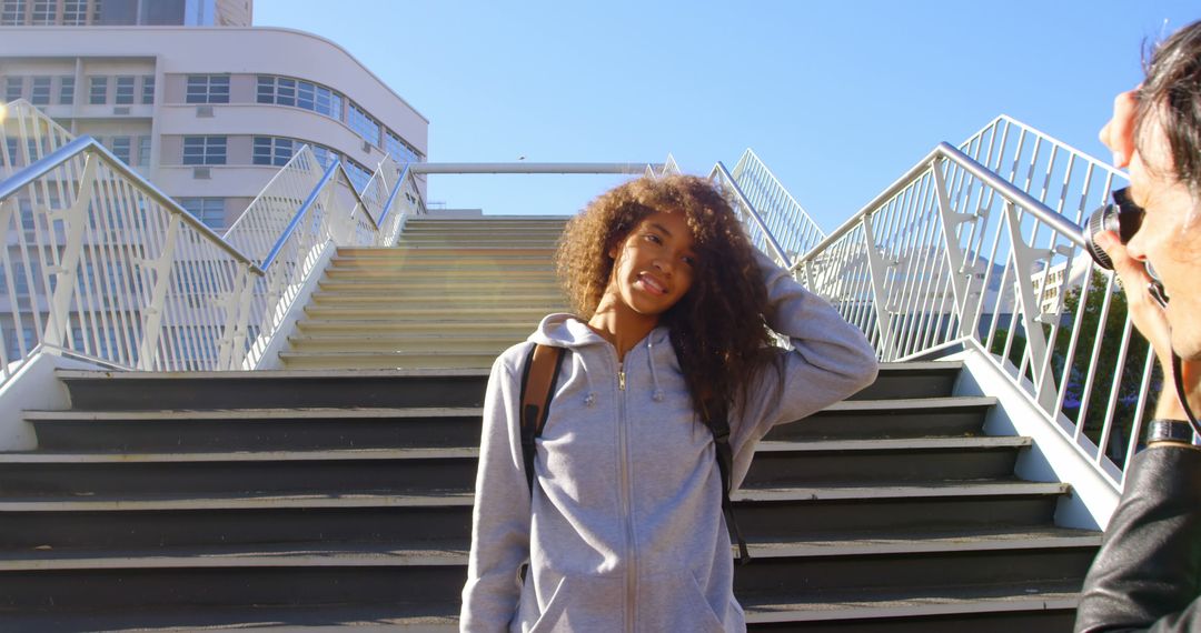 Smiling Teen Girl Posing on Urban Staircase in Bright Sunlight - Free Images, Stock Photos and Pictures on Pikwizard.com