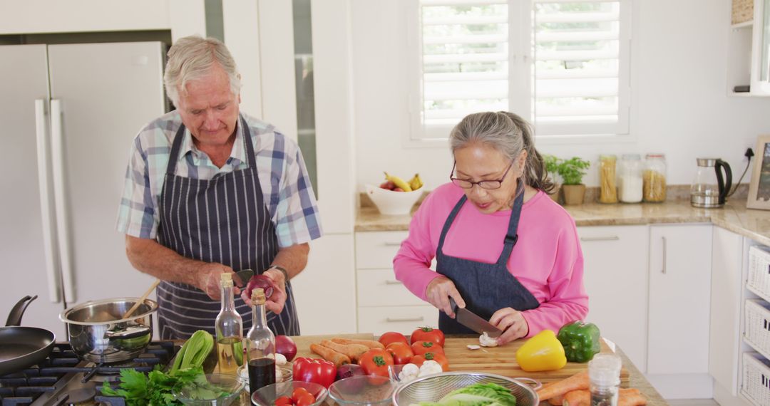 Happy Diverse Senior Couple Cooking Together in Modern Kitchen - Free Images, Stock Photos and Pictures on Pikwizard.com