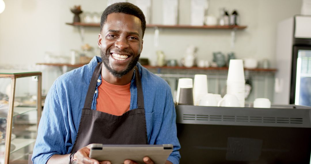 Friendly Barista Smiling Holding Tablet in Cozy Café Environment