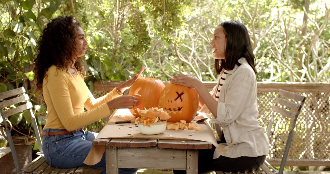 Multiracial Friends Enjoying Pumpkin Carving on Sunny Porch