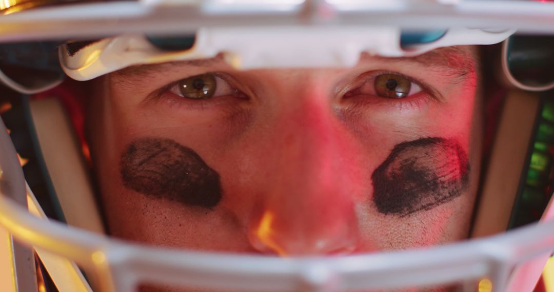 Close-Up of Football Player with Helmet and Eye Black Stripes - Free Images, Stock Photos and Pictures on Pikwizard.com