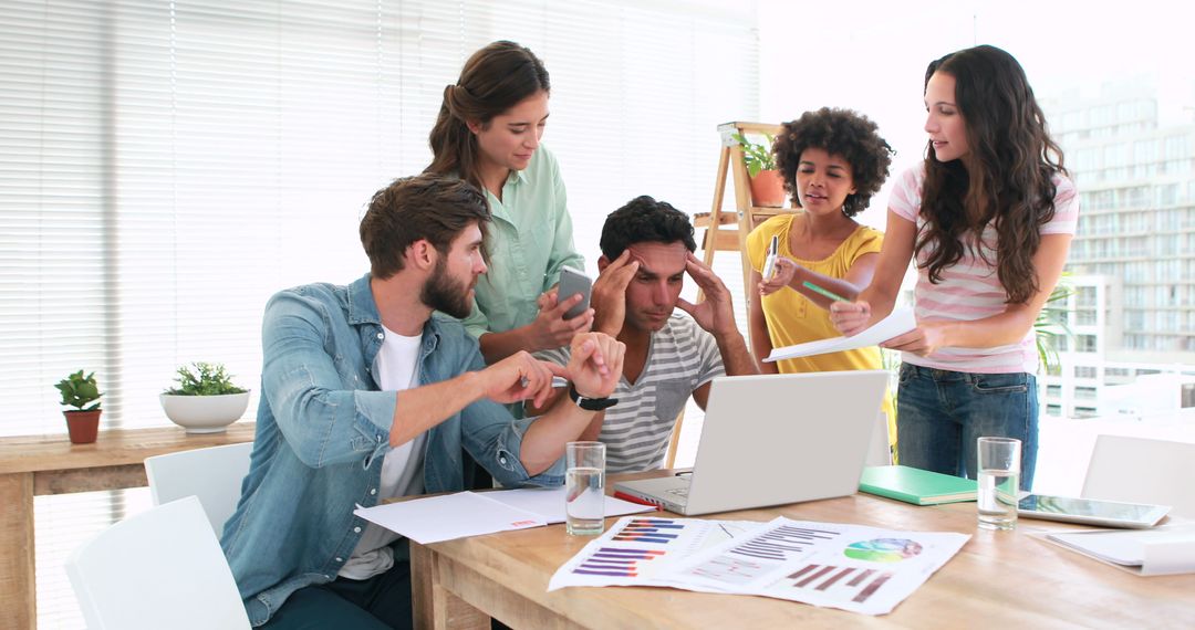 Diverse Team Engaging in Lively Office Brainstorming Session