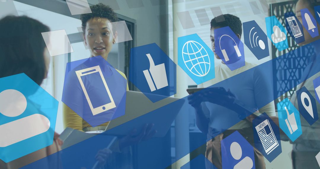 Women Collaborating in Modern Office Under Digital Communication Icons Overlay Planning