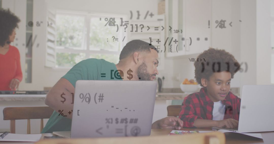 Father and Son Coding on Laptops with Digital Interface Overlay