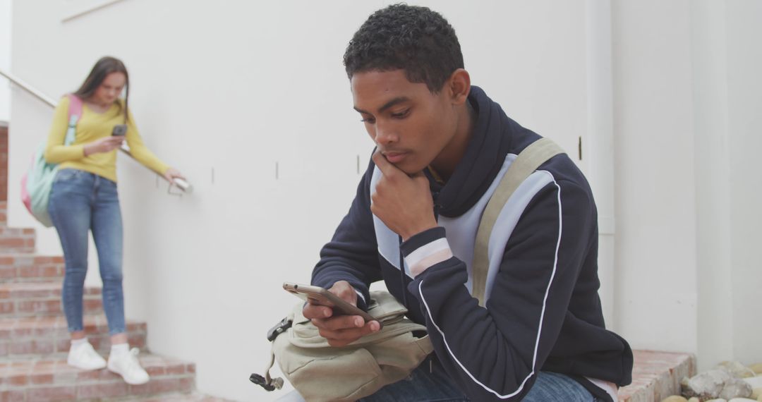 Male Student Using Smartphone at School