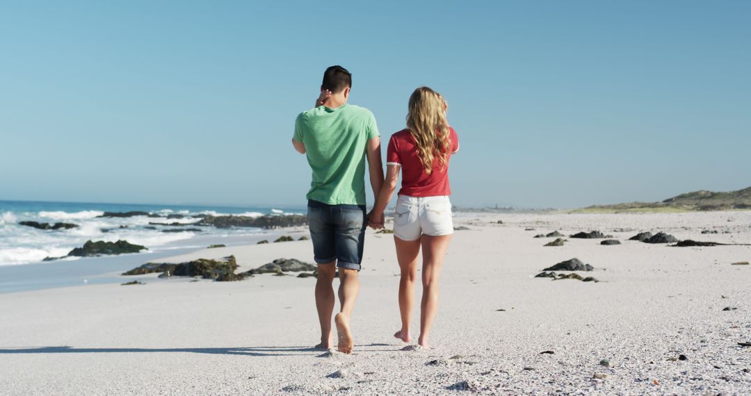 Couple Walking Barefoot on Beach with Clear Blue Sky - Free Images, Stock Photos and Pictures on Pikwizard.com