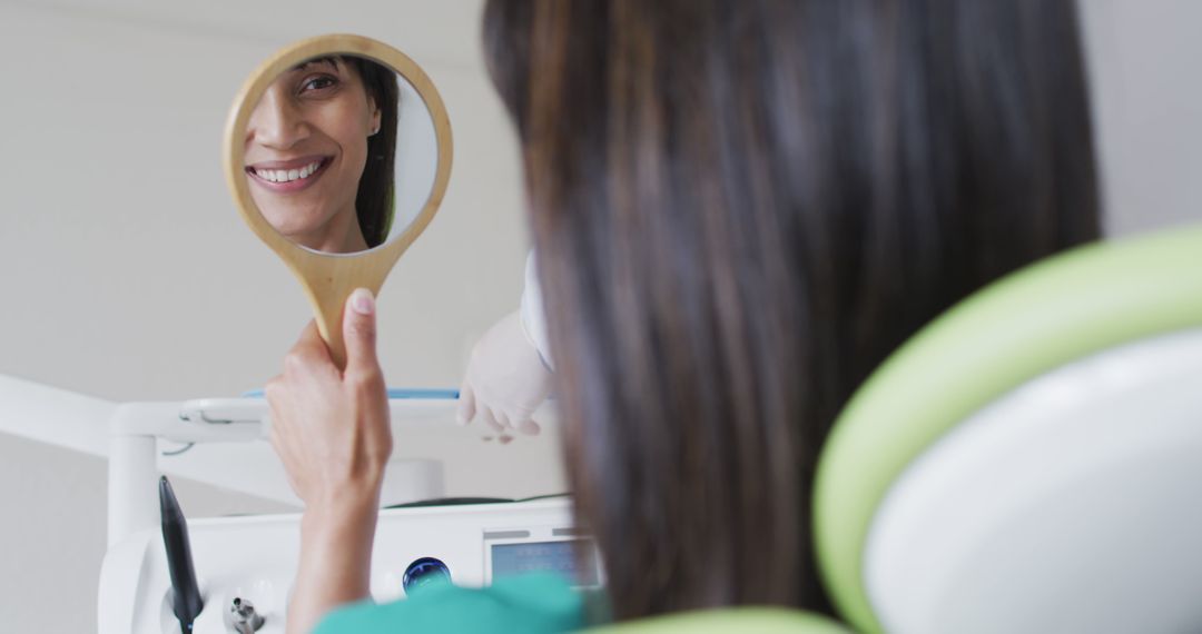 Happy Woman with Hand Mirror at Dentist Clinic - Free Images, Stock Photos and Pictures on Pikwizard.com