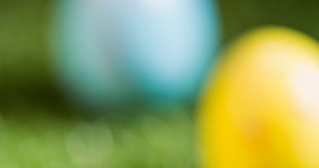 Blurred Colorful Easter Eggs on Grass
