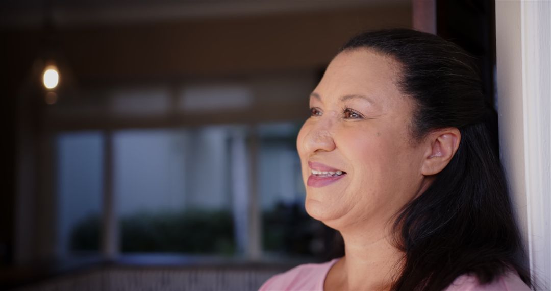 Smiling Mature Woman Standing Indoor with Joyful Expression