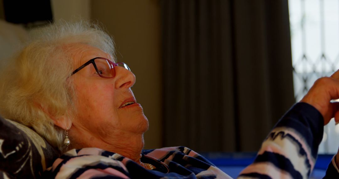 Senior Woman Relaxing at Home Wearing Glasses - Free Images, Stock Photos and Pictures on Pikwizard.com