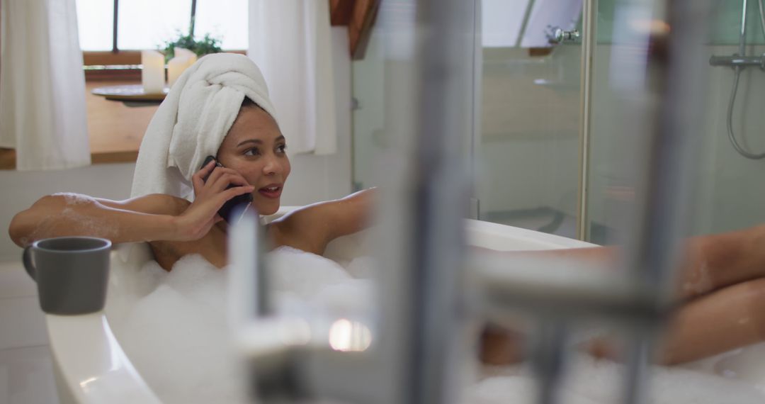 Woman Relaxing in Bubble Bath and Talking on Phone - Free Images, Stock Photos and Pictures on Pikwizard.com