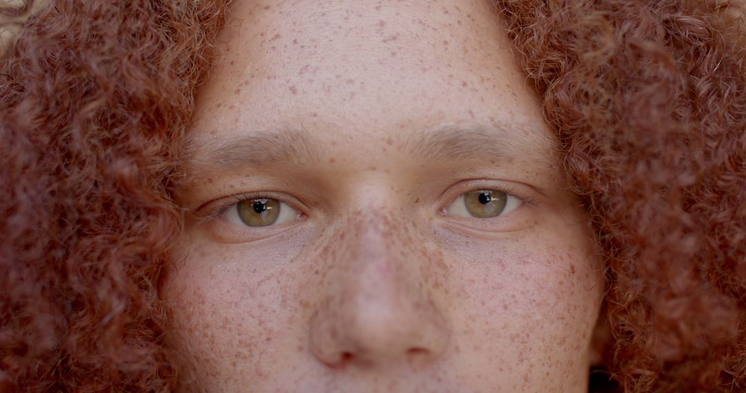 Portrait of eyes of caucasian man with ginger curly hair and freckles at sunny home - Free Images, Stock Photos and Pictures on Pikwizard.com