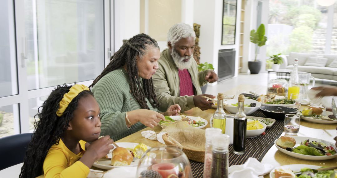 Multigenerational Family Sharing Sunlit Home Dinner Around Table Enjoying Salad and Bread