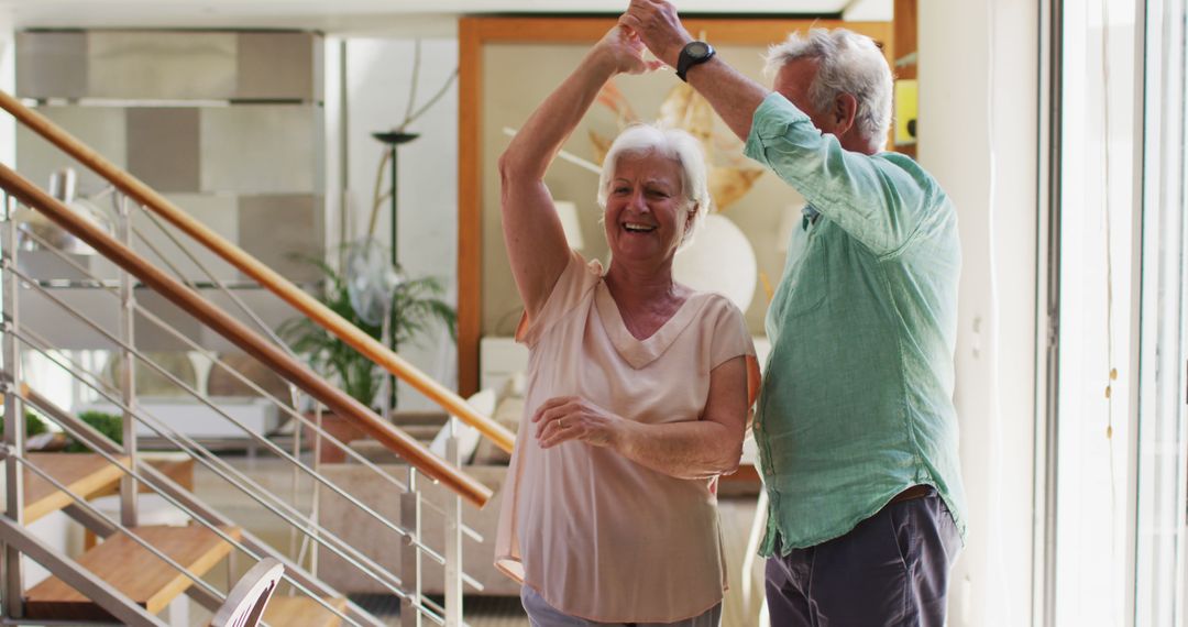 Smiling Senior Couple Enjoying Dance in Modern Home