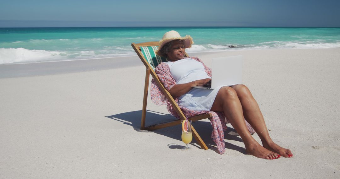 Senior Woman Relaxing on Tropical Beach and Using Laptop - Free Images, Stock Photos and Pictures on Pikwizard.com