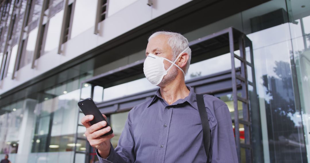 Senior Man with Face Mask Using Smartphone Outdoors - Free Images, Stock Photos and Pictures on Pikwizard.com