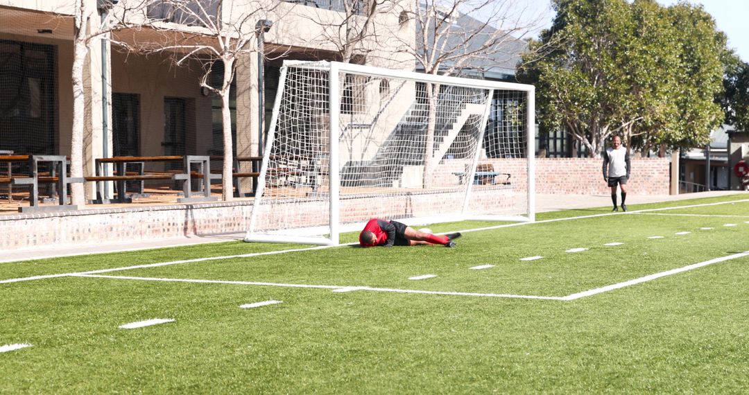 Young Soccer Players Practicing on Sunny Day Near Goalpost