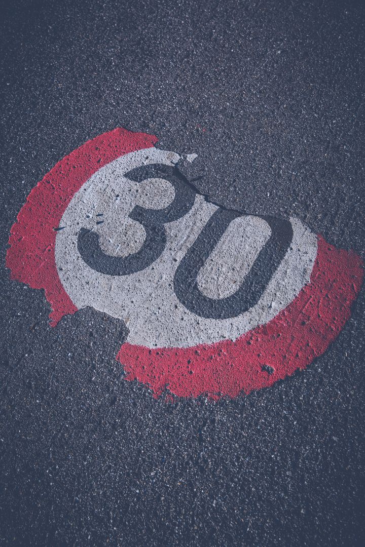 Faded 30 km/h Road Speed Limit Sign on Asphalt - Free Images, Stock Photos and Pictures on Pikwizard.com